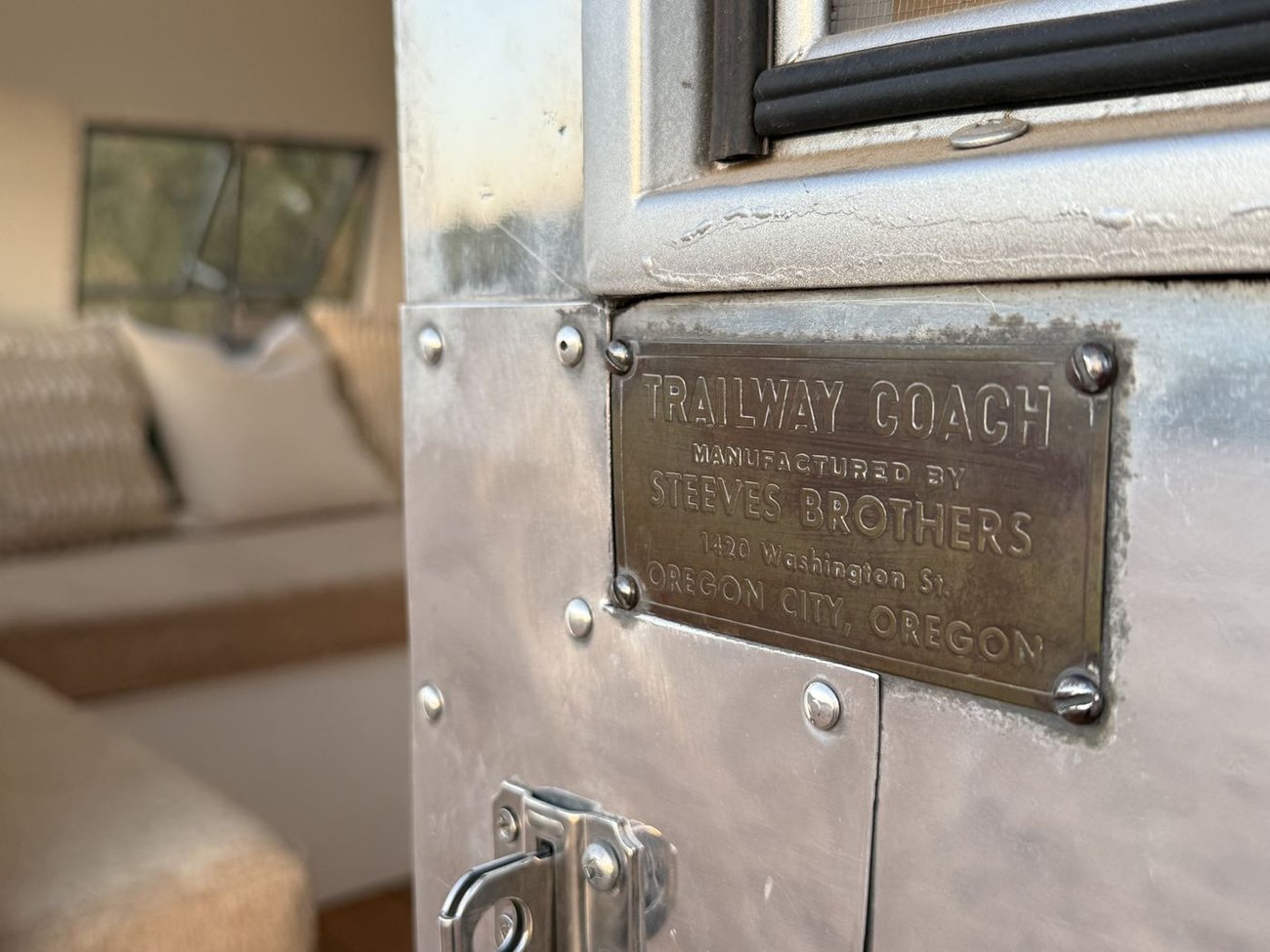 Brass Trailway Coach maker's plate with a peek into the trailer interior